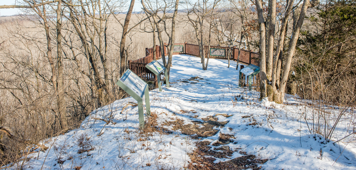 snow covered path leading to interpretive panels and overlook deck