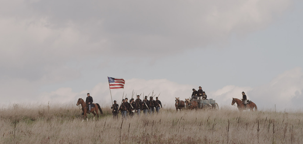 Illustration of soldiers on horseback with flag on prairie