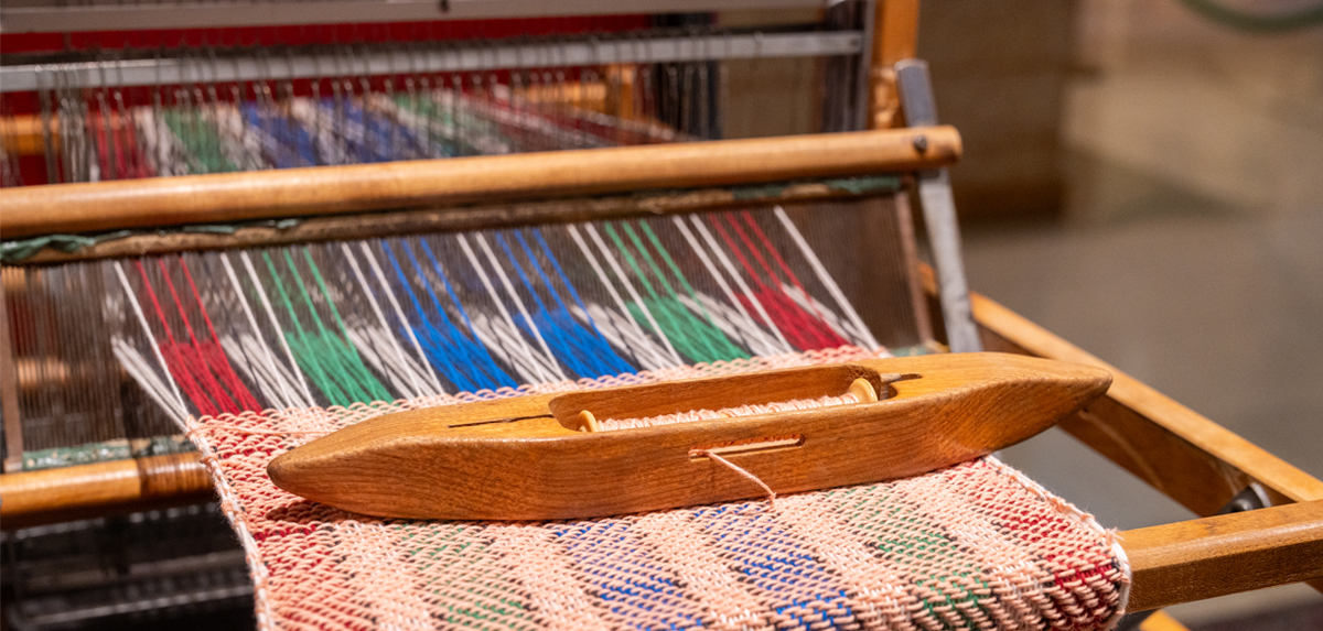 Image of a weaving maching with colorful weave being created