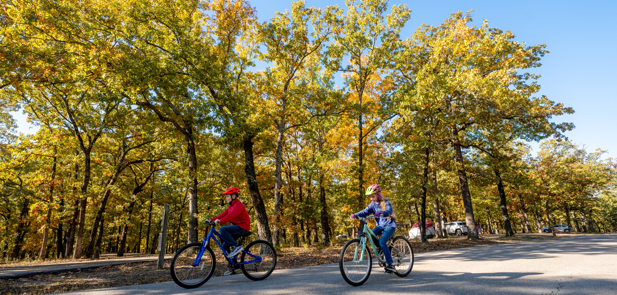 Two children riding their bikes